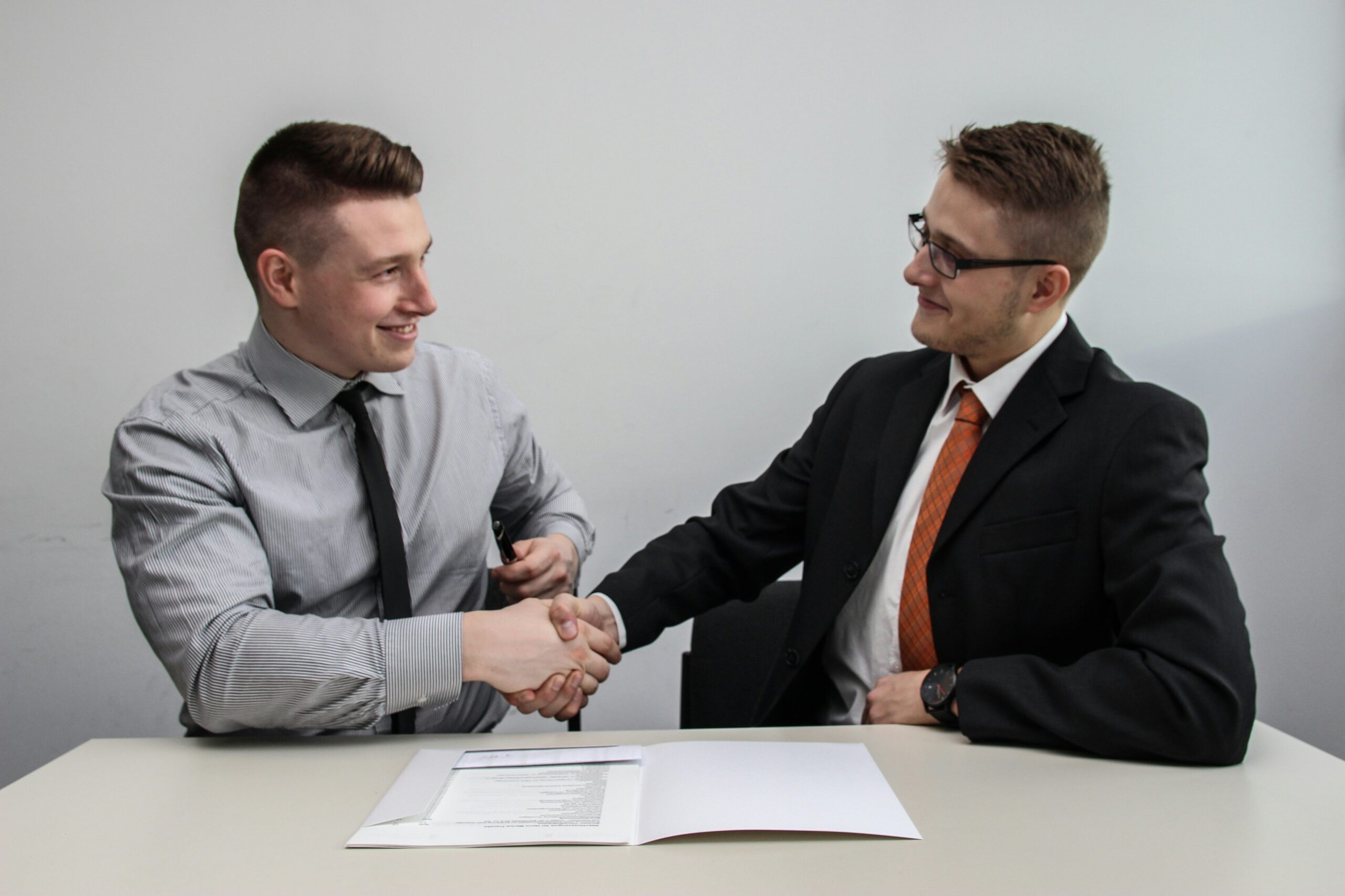 Two people sitting at a table reviewing documents