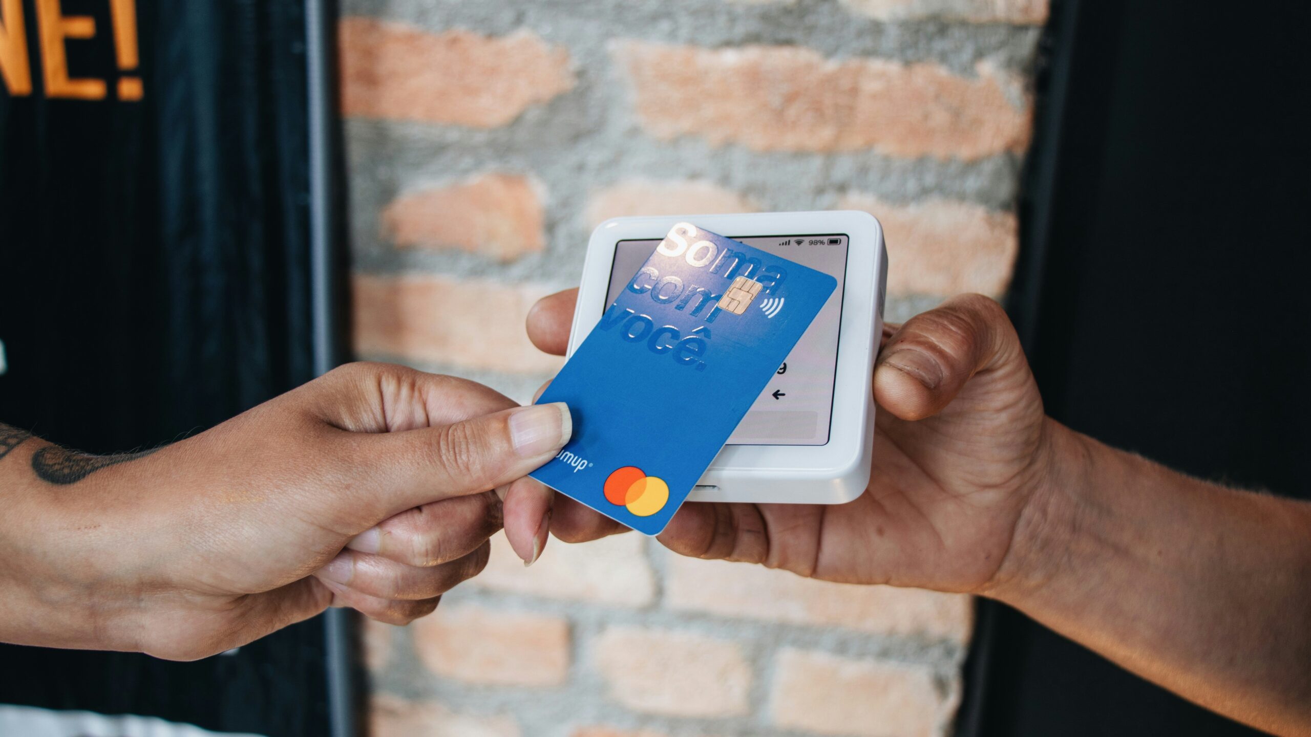 Happy couple smiling while holding a joint credit card