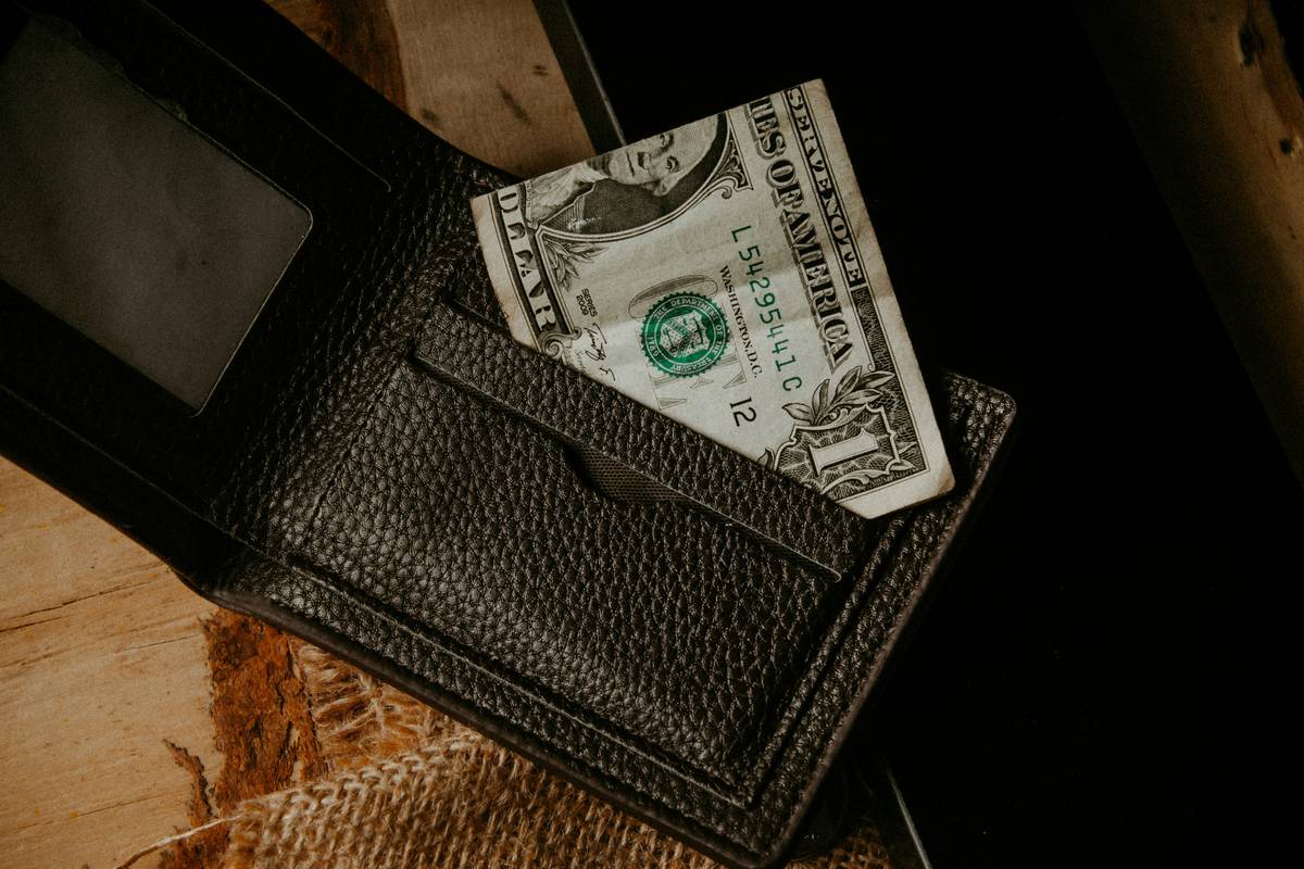 Two hands holding a credit card together symbolizing shared responsibility