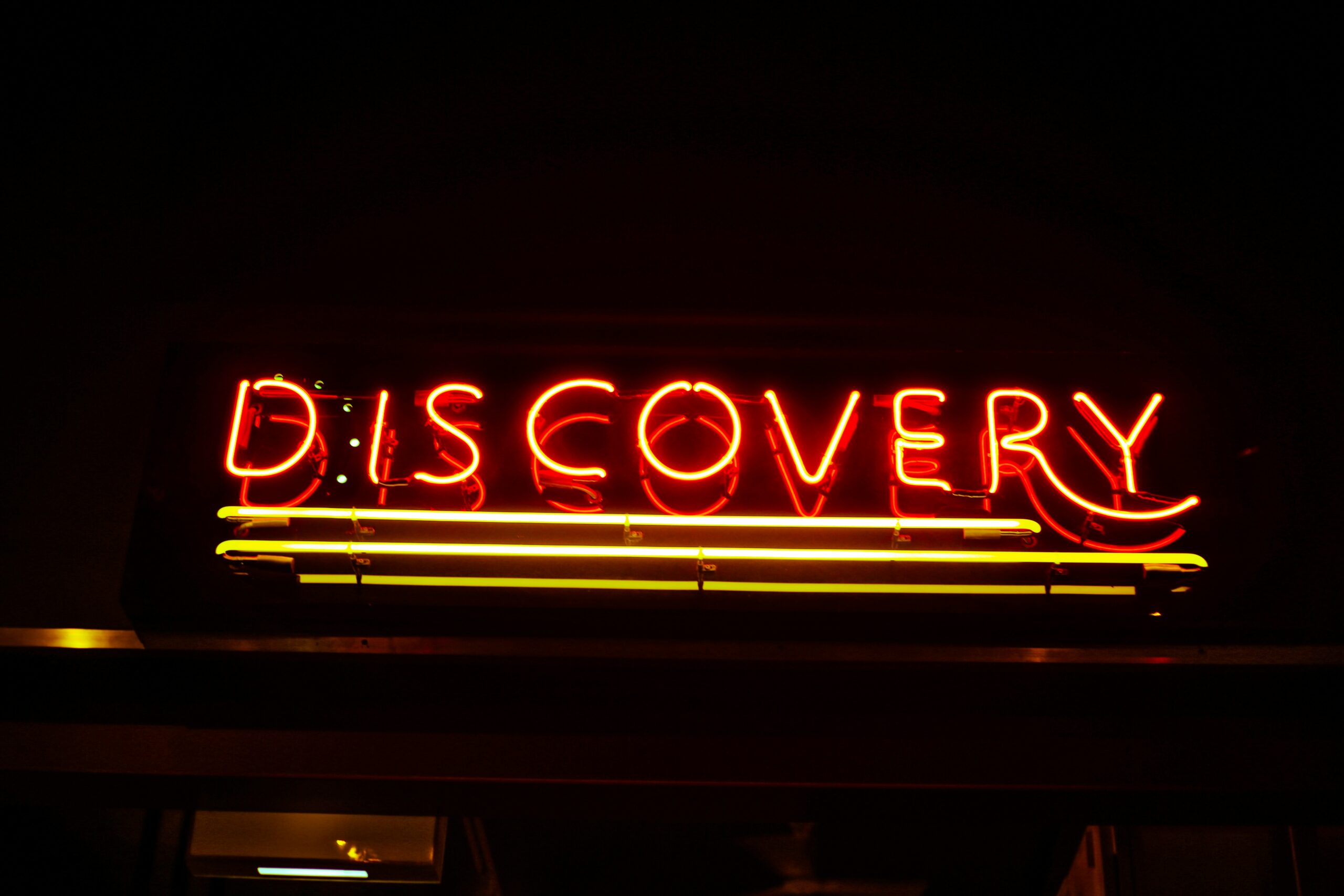 lighted red Discovery neon signage