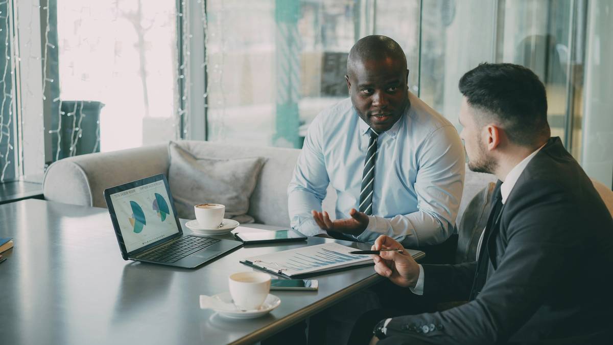 Illustration showing couple discussing finances at kitchen table